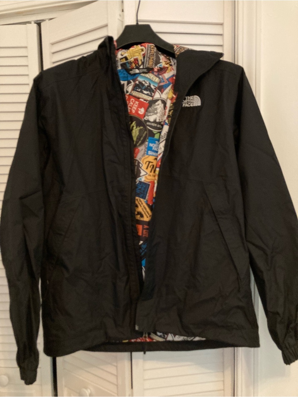 The North Face Men’s Black Hooded Windbreaker with Colorful Graphic Liner